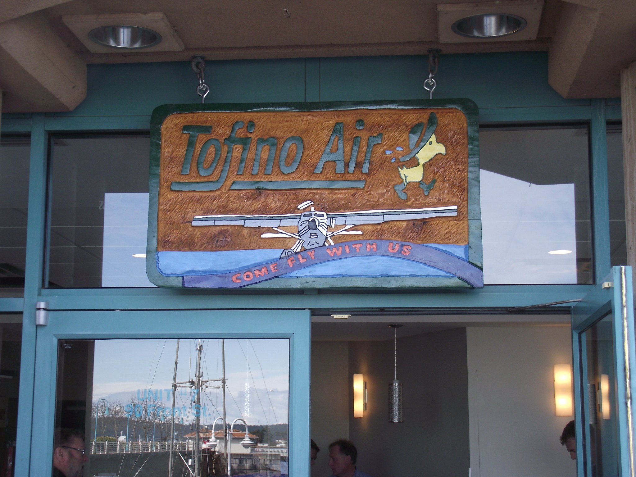 3-foot wide sign, Tofino Air, plane taking off.